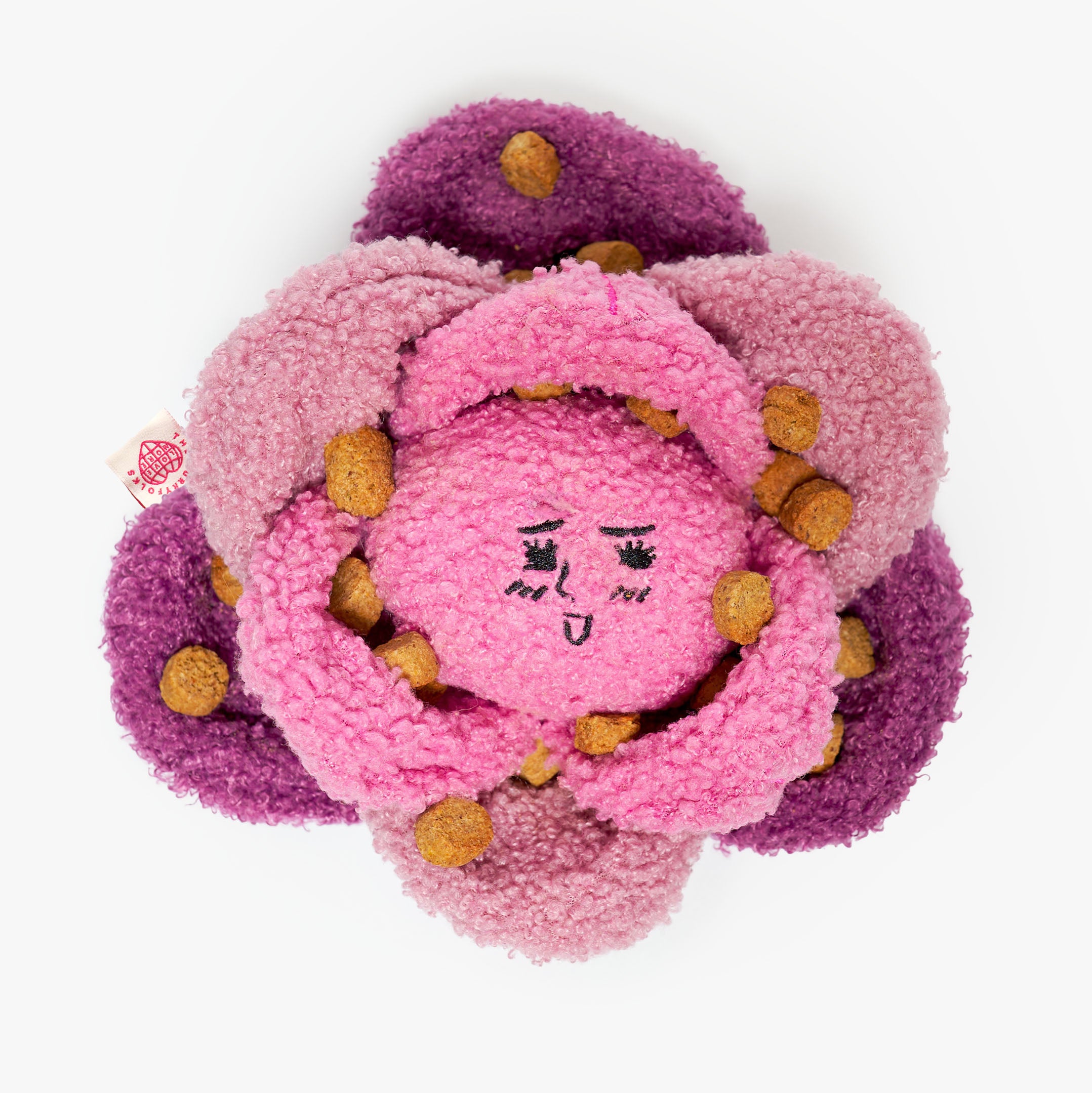 Floral-shaped plush toy with a face on a white background