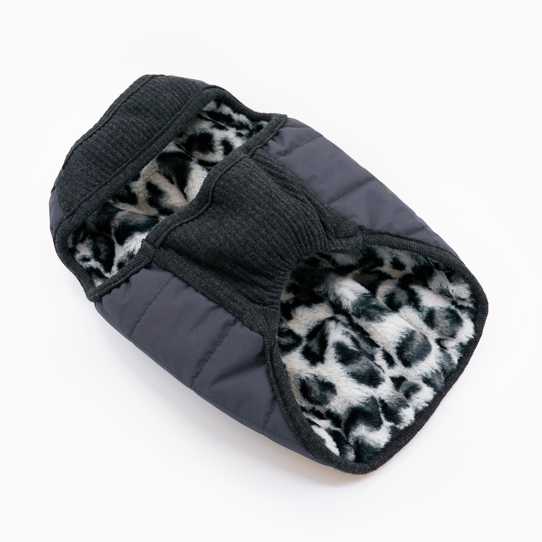 Black pet coat with leopard print lining on a white background