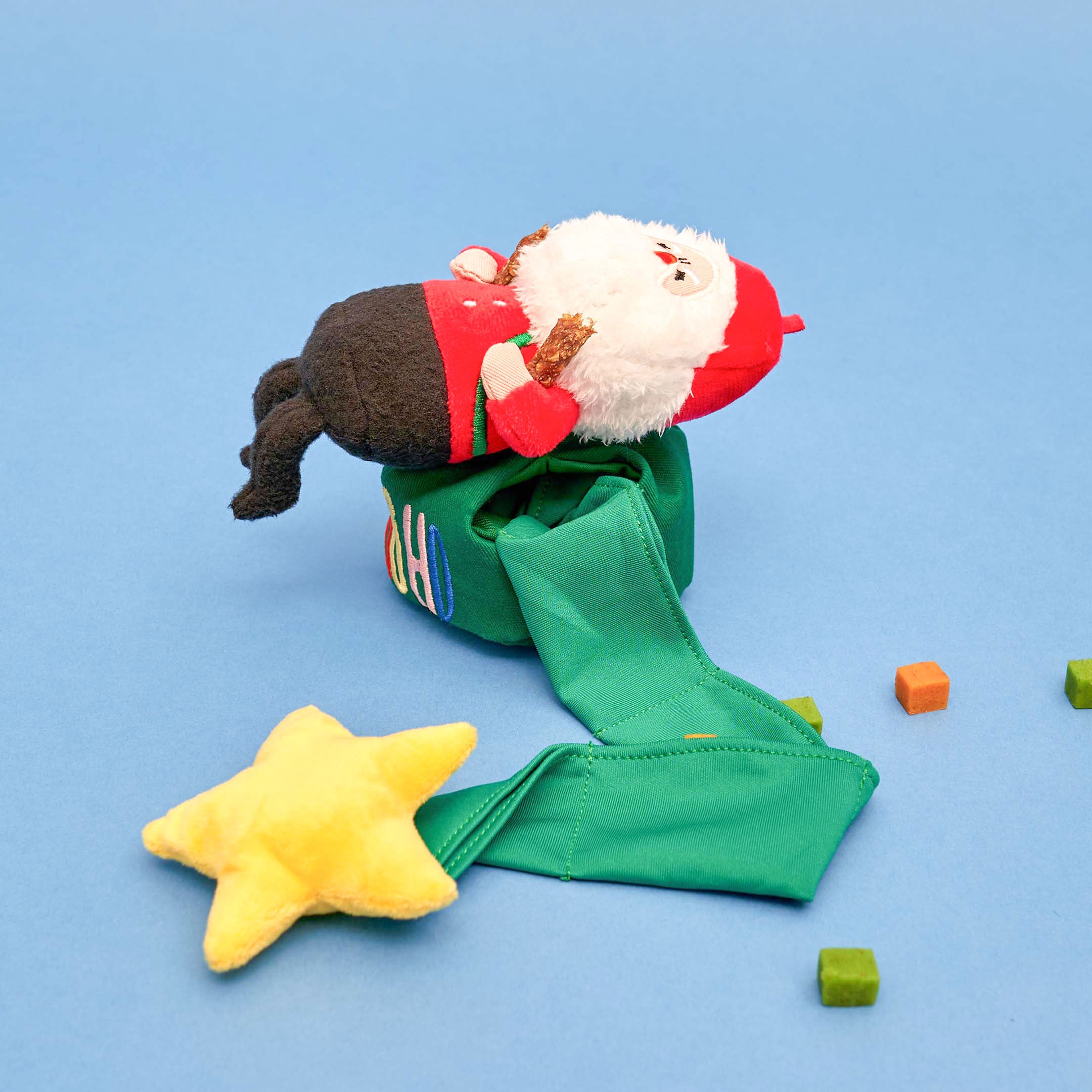 A colorful and interactive holiday toy for dogs, featuring Santa Paws and festive decorations.