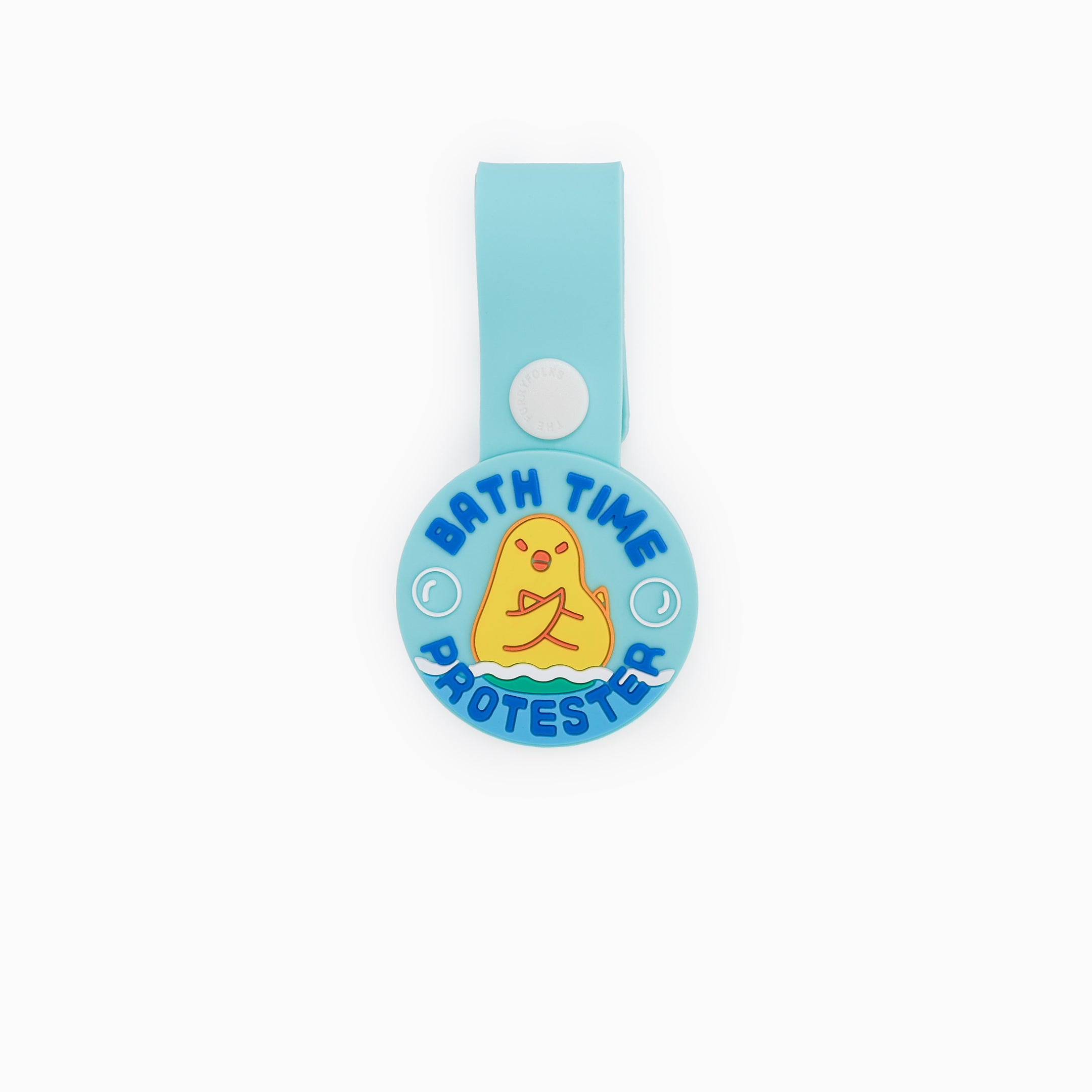 A light blue dog tag with the text ‘Bath Time Protester’ and an illustration of a dog crossing its paws in protest. The tag is made of non-toxic rubber and features a loop for attaching to a collar or harness. It has a fun and playful design, ideal for dogs who dislike baths.