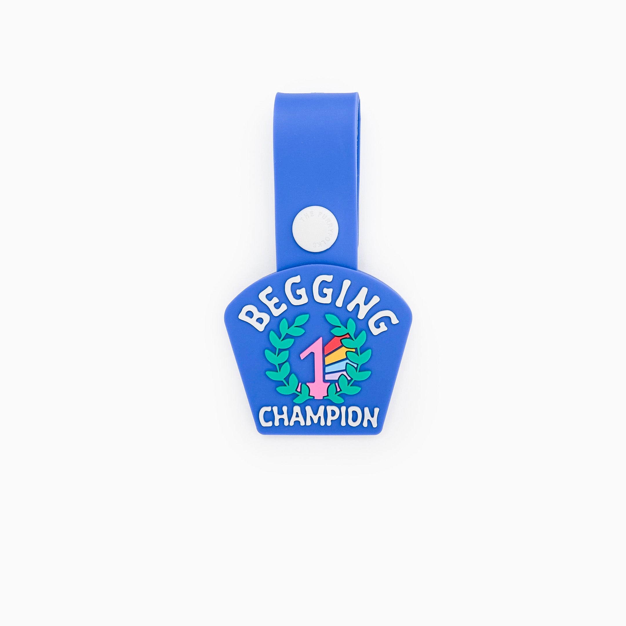 A blue dog tag with the text ‘Begging Champion’ and an illustration of a number 1 medal surrounded by laurel leaves. The tag is made of non-toxic rubber and features a loop for attaching to a collar or harness. It has a fun and playful design, ideal for dogs who are experts at begging for treats.