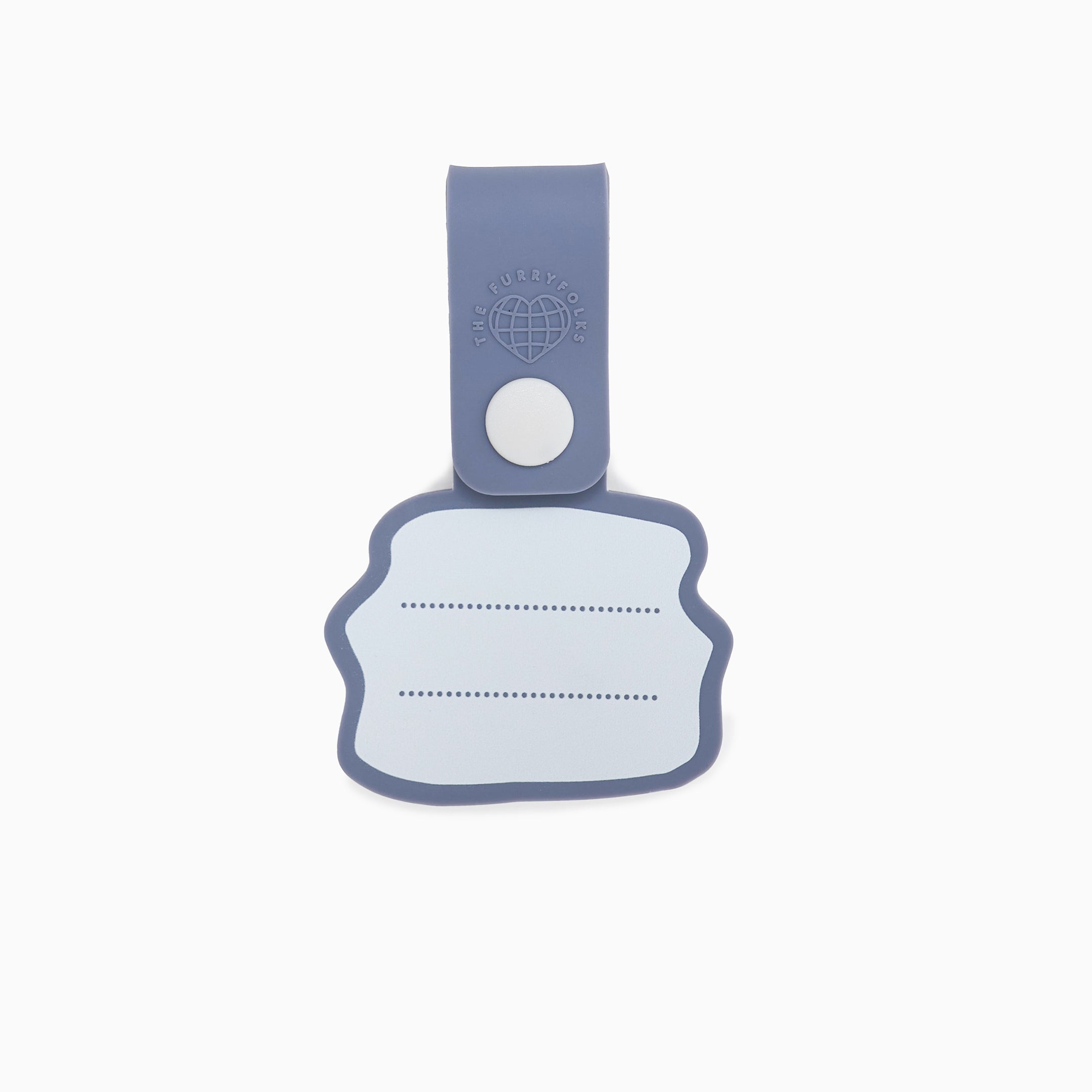 Back view of a dog tag with a light blue strap and a white button, featuring a blank white space with dotted lines for writing a pet’s name and contact details. This practical and customizable tag is part of The Furryfolks’ Daily Clip product line, made from 100% non-toxic rubber and designed to be securely attached to a dog leash or collar.